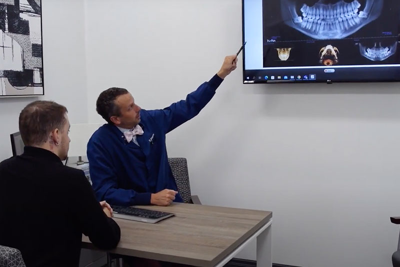 doctor going over dental procedure information with patient