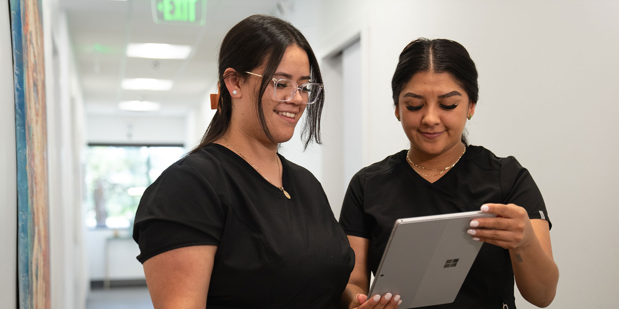 team members looking at tablet
