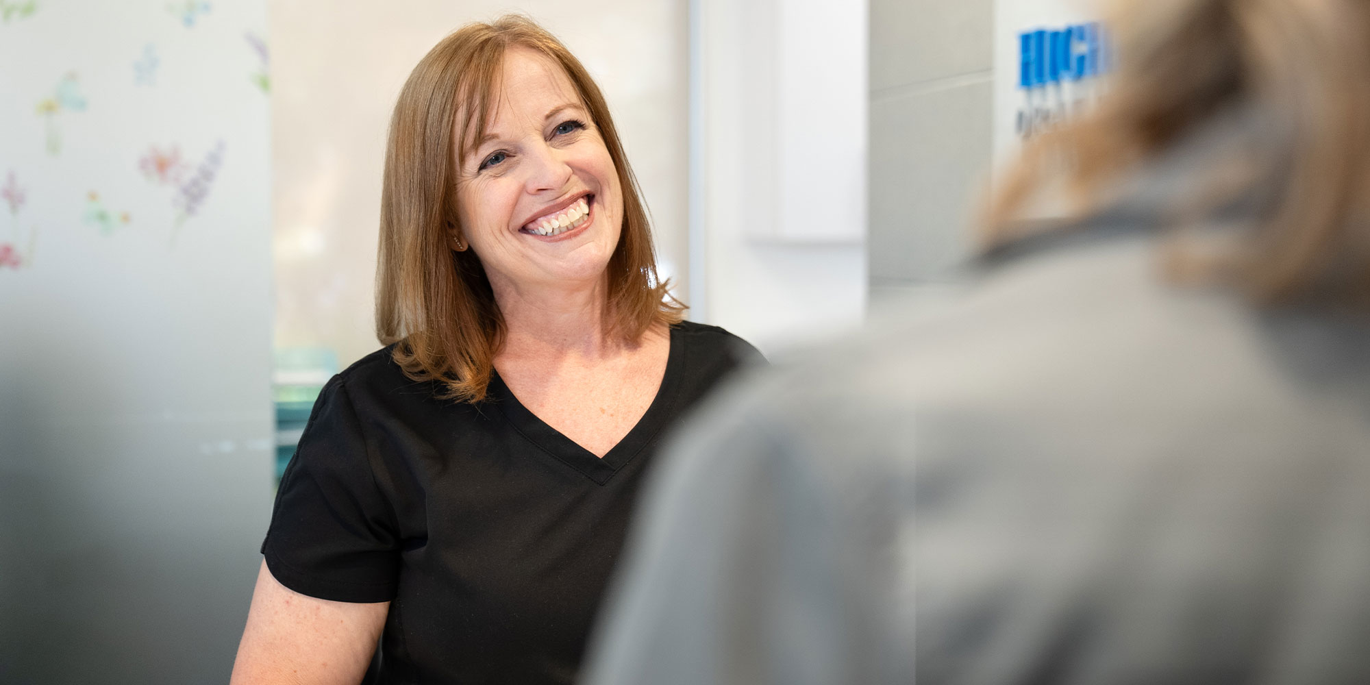 team member Checking in Patient into dental office