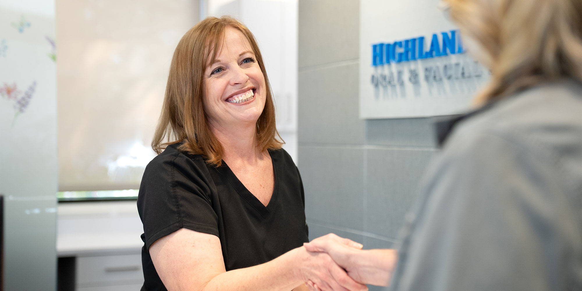 Team member greeting Paitent into office
